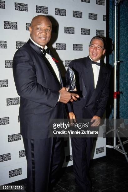 American boxer George Foreman and American actor Tony Danza, both wearing tuxedos and bow ties, in the press room of the 4th Annual Jim Thorpe Pro...