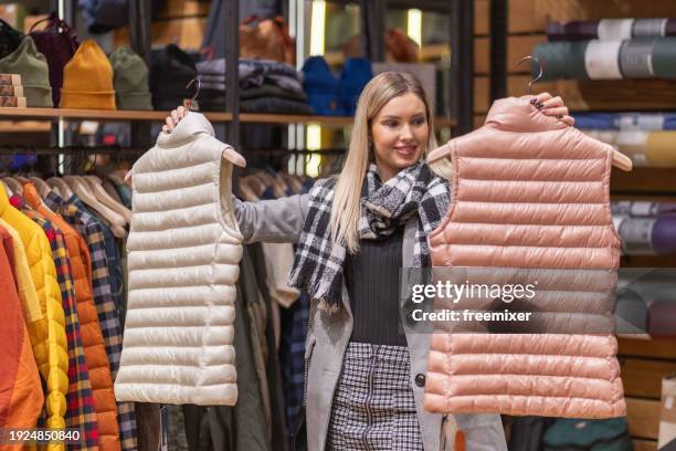 blonde woman in shopping - waistcoat stock pictures, royalty-free photos & images
