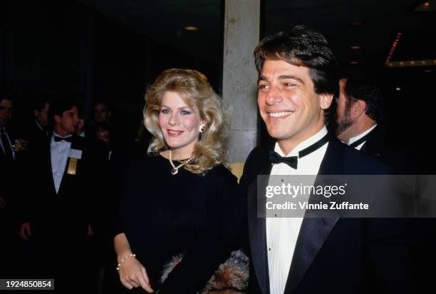 American actor Tony Danza, wearing a tuxedo and bow tie, and his wife, Tracy, who wears a black outfit with a pearl necklace and a heart-shaped...