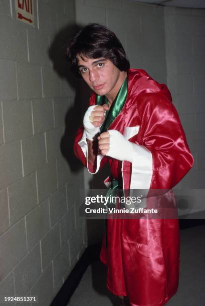 American actor Tony Danza, wearing a red robe with white and green trim, reflecting Danza's Italian heritage, and white hand wraps, posing in a fight...