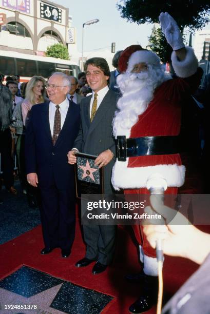 American radio personality and television producer Johnny Grant, honorary mayor of Hollywood, American actor Tony Danza, and a person in a Santa...