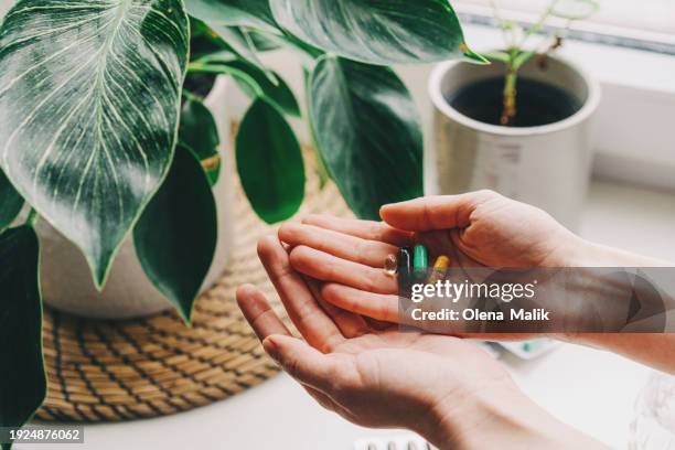 woman taking vitamins and supplements. medical concept. - fish oil stock photos et images de collection