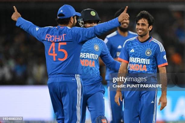 India's Ravi Bishnoi celebrates with captain Rohit Sharma after taking the wicket of Afghanistan's Rahmanullah Gurbaz during the second Twenty20...