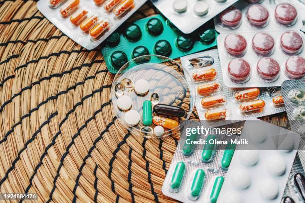 large group of assorted pills and blisters. medical concept. - hrt pill stock-fotos und bilder