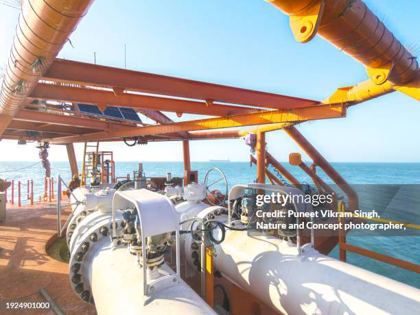 an assembly of piping and control valves on a single point mooring buoy (spm) to transfer the crude oil from and oil tanker to the subsea pipeline end manifold - jamnagar refinery stock pictures, royalty-free photos & images