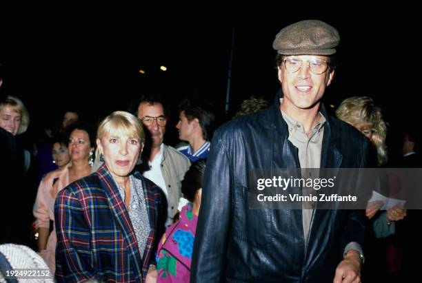 American actor Ted Danson, wearing a black leather jacket and a tweed flat cap, and his wife, Casey Danson, who wears a plaid jacket, attend a Cirque...