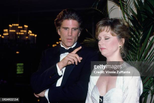 American actor Ted Danson, wearing a tuxedo and bow tie, points with his right index finger, beside American actress, comedian and singer Shelley...