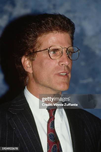 American actor Ted Danson, wearing a black pinstripe suit over a white shirt and a red-and-blue tie, in the press room of the inaugural Environmental...