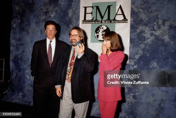 American actor Ted Danson, wearing a black pinstripe suit over a white shirt and a red-and-blue tie, American cartoonist and animator Matt Groening,...
