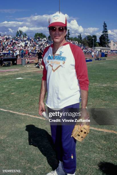 American actor Ted Danson, wearing a red-and-white shirt and matching baseball cap, both featuring the 'Narconon All-Stars' logo, attends the 12th...