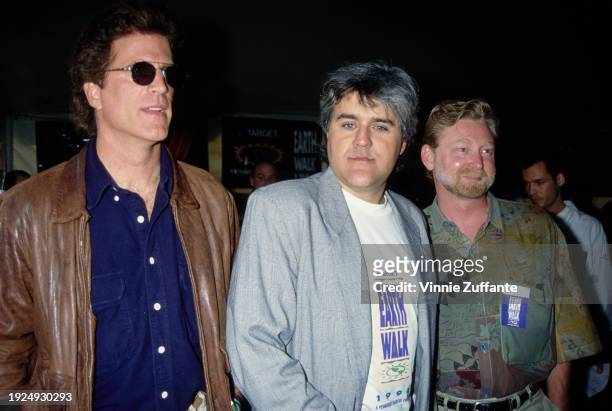 American actor Ted Danson, wearing a dark blue shirt under a brown leather jacket, American comedian and talk show host Jay Leno, who wears a grey...