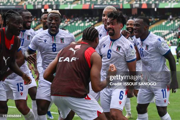 Equatorial Guinea's midfielder Iban Edu celebrates with teammates after scoring his team's first goal during the Africa Cup of Nations 2024 group A...