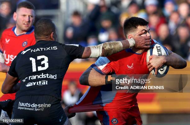 Racing92's French centre Gael Fickou tackles Bath's English wing Will Muir during the European Rugby Champions Cup pool 2 match between Bath and...