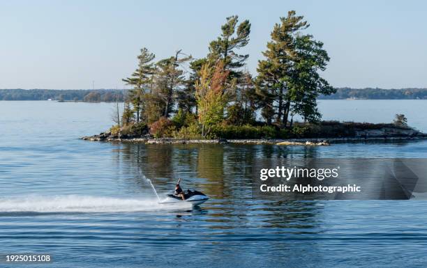 one of the thousand islands near gananoque on lake ontario - jet ski ストックフォトと画像