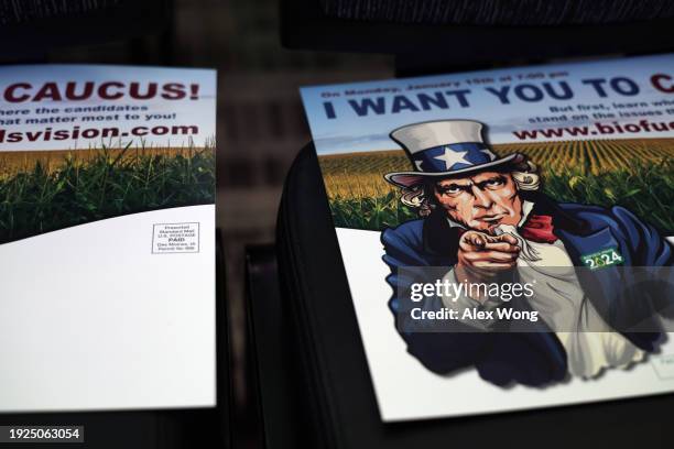 Signs encouraging people to attend the presidential caucus are seen during the 2024 Iowa Renewable Fuels Summit on January 11, 2024 in Altoona, Iowa....