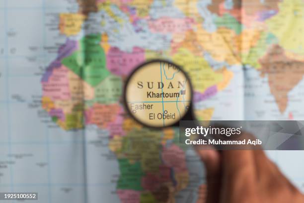 sudan and magnifying glass on world map - sudan bildbanksfoton och bilder