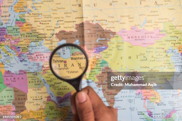 iran and magnifying glass on world map - japan map magnifying glass stock pictures, royalty-free photos & images