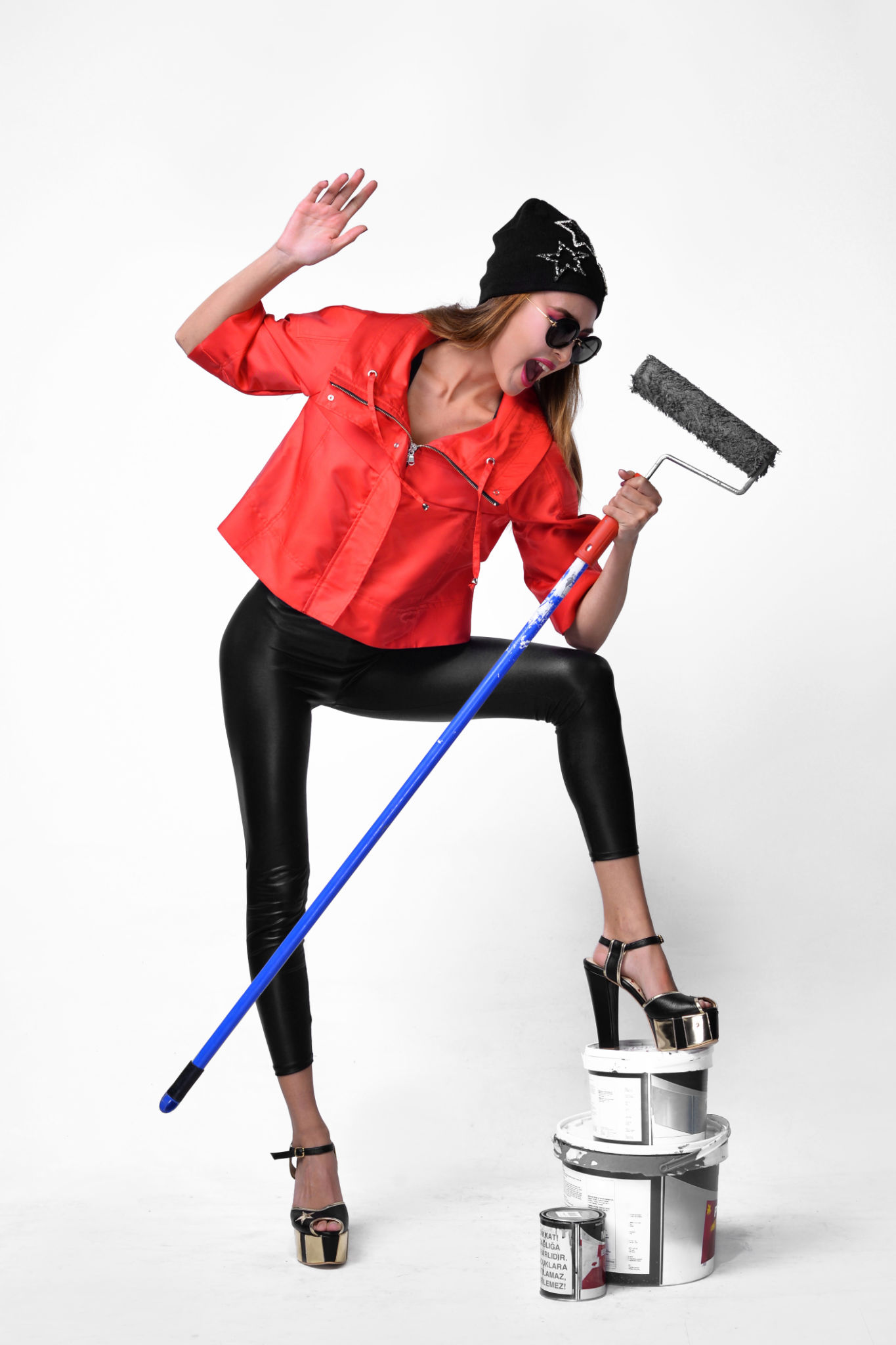 Girl wearing a red sweatshirt creates an artistic image with paint and whitewash materials. Girl wearing a red sweatshirt creates an artistic image with paint and whitewash materials.