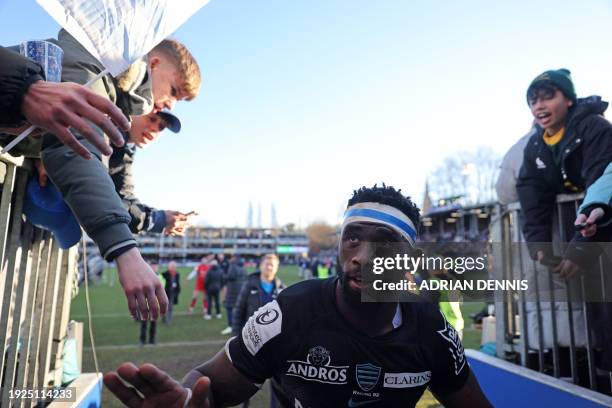 Racing92's South African flanker Siya Kolisi grrets fans as he leaves the pitch after the European Rugby Champions Cup pool 2 match between Bath and...