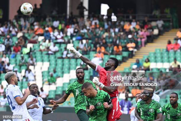 Equatorial Guinea's goalkeeper Jesus Owono hits the ball away to make a save during the Africa Cup of Nations 2024 group A football match between...