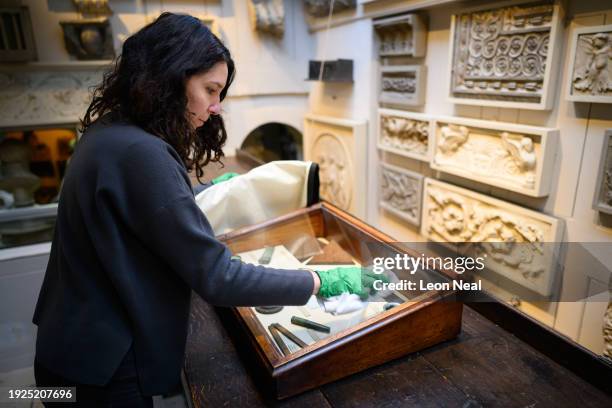 Conservator Chiara Rapani cleans and dusts a display case in the Drawing Office during the Sir John Soane's Museum annual cleaning week on January...