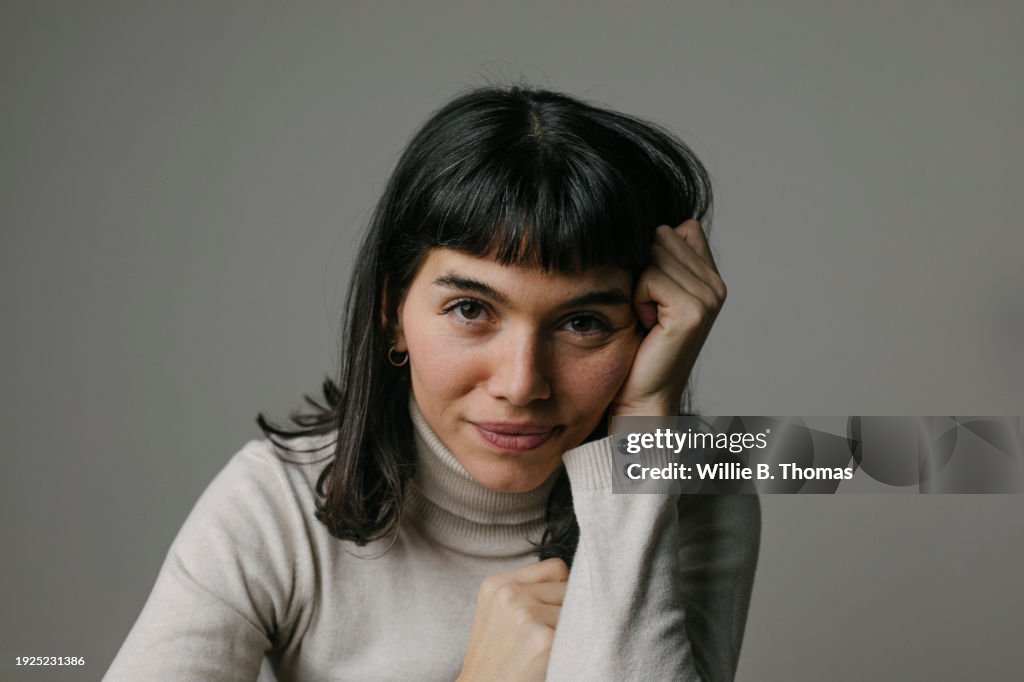 Portrait Of Woman With Hand And Head Looking Into Camera