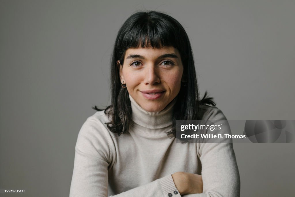 Portrait Of Woman Leaning Forward On Elbows, Smilng
