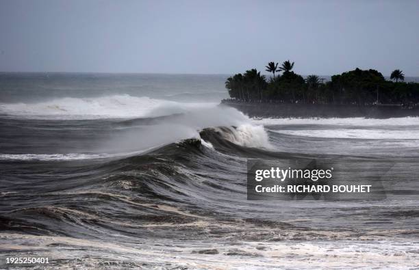 Waves crash on the shore of Saint-Denis de la Reunion on January 14, 2024 as authorities on France's Indian Ocean Reunion Island urged residents to...