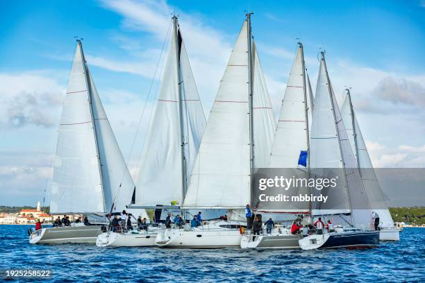 sailing crews on sailboats on regatta - jib stockfoto's en -beelden