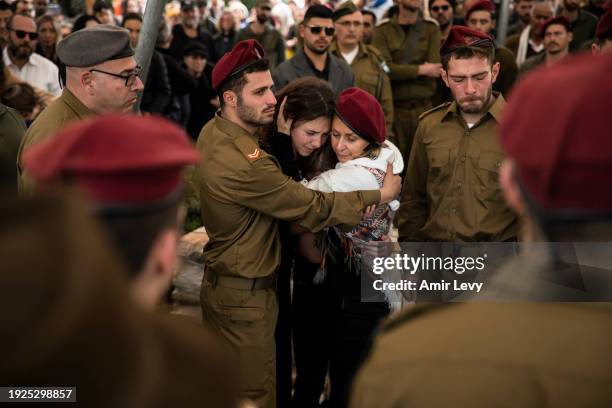 Aviva hugs her daughter Eden and her son's friends from the unit during the funeral of her son Master Sgt. Daniel Weidenbaum on January 14, 2024 in...