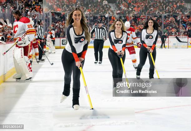 Members of the Philadelphia Flyers ice girls clean the ice during a timeout against the Calgary Flames at the Wells Fargo Center on January 6, 2024...