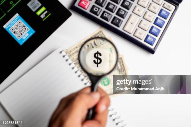 businessman magnifying us dollar with a magnifying glass on white office background. - company president stock pictures, royalty-free photos & images