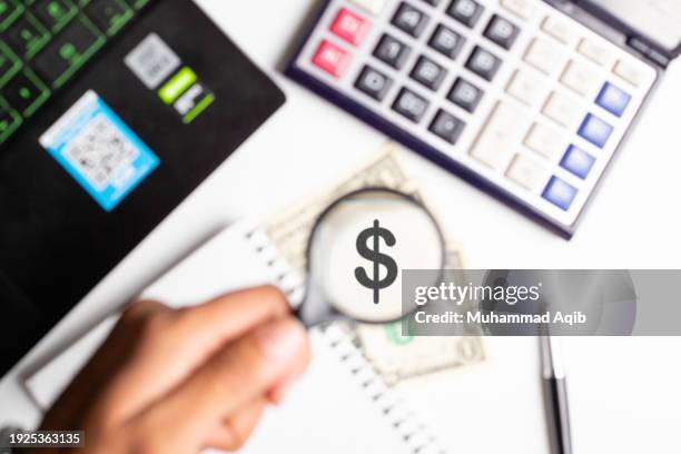 businessman magnifying us dollar with a magnifying glass on white office background. - company president stock pictures, royalty-free photos & images