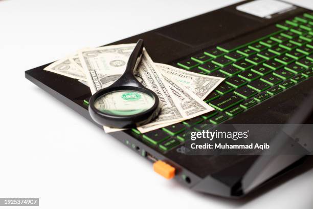 laptop, us dollar and magnifying glass on white office table. - company president stock pictures, royalty-free photos & images