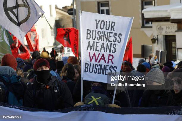 Protestors holding banners during a demonstration against the World Economic Forum ahead of its start in Davos, Switzerland, on Sunday, Jan. 14,...