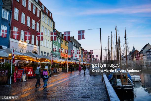 The historic harbour Nyhavn in Copenhagen celebrates the the change of throne with danish flags on January 10, 2024 in Copenhagen, Denmark. On...
