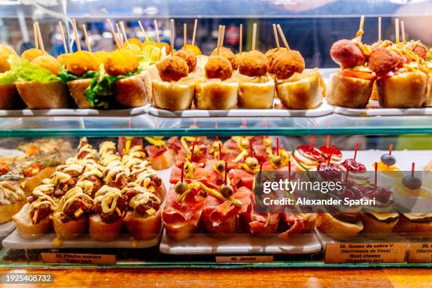 various pincho tapas at the bar in barcelona, spain - tapas stock pictures, royalty-free photos & images
