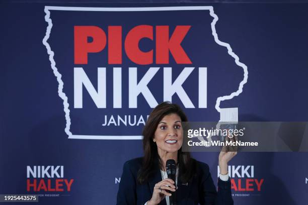 Republican presidential candidate former U.N. Ambassador Nikki Haley holds up a commit to caucus card while speaking during a campaign event on...