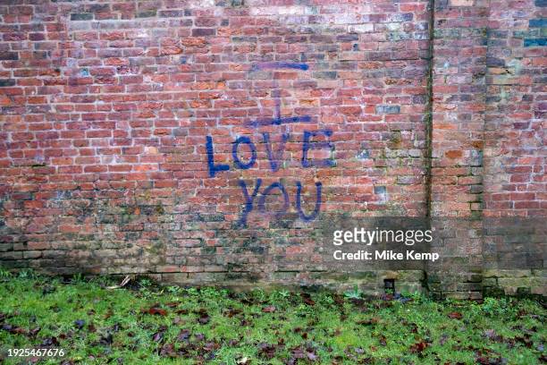 Love you graffiti spray painted on a wall in Kings Heath on 4th January 2024 in Birmingham, United Kingdom.