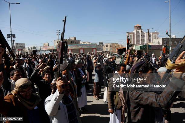Yemeni protestors loyal to the Houthi movement lift their rifles as they participate in a protest held against Israel's ongoing war on Gaza and...