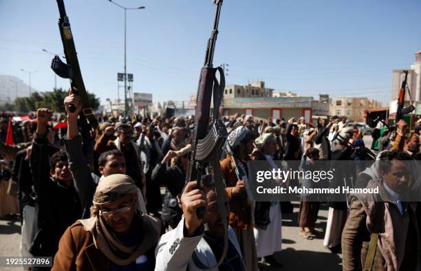 Yemeni protestors loyal to the Houthi movement lift their rifles as they participate in a protest held against Israel's ongoing war on Gaza and...