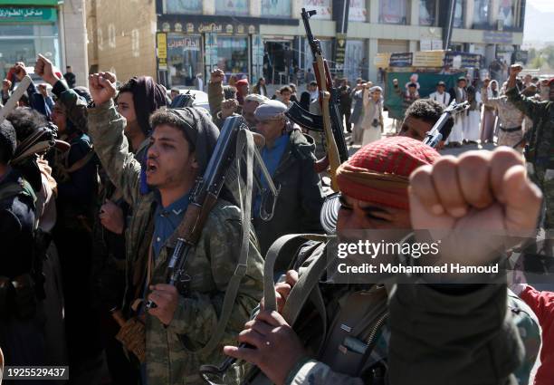 Yemeni protestors loyal to the Houthi movement lift their rifles as they participate in a protest held against Israel's ongoing war on Gaza and...