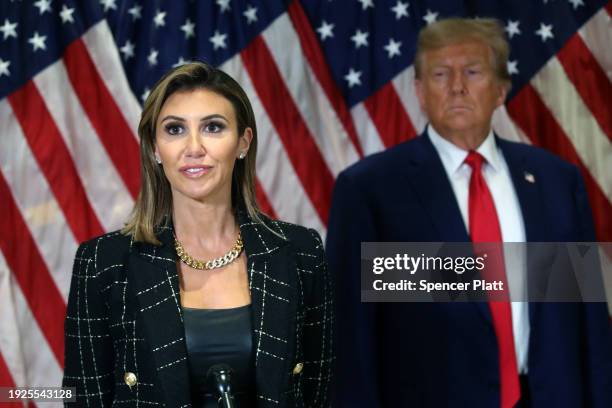 Former U.S. President Donald Trump stands with his lawyer Alina Habba as she speaks to the media at one of his properties, 40 Wall Street, following...