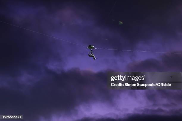 The television spider cam is visible against the purple sky during the Premier League match between Manchester United and Tottenham Hotspur at Old...