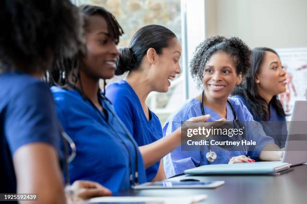diverse group of nurses and medical students attend healthcare conference or class together - asian-students-classroom-computer stock pictures, royalty-free photos & images