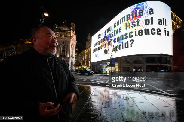 Artist Ai Wei Wei looks on as the first of 81 nightly questions is displayed on a screen at Piccadilly Circus on January 11, 2024 in London, England....