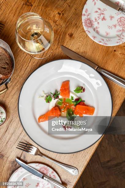 elegant salmon appetizer dish with smoked salmon, salmon caviar, vinaigrette and radish cream served  in michelin star restaurant - radish vinaigrette stock pictures, royalty-free photos & images