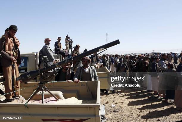 Members of different tribes shout anti-US slogans with guns in hands as they stage a protest against United States' attacks on Yemen's Houthis near...