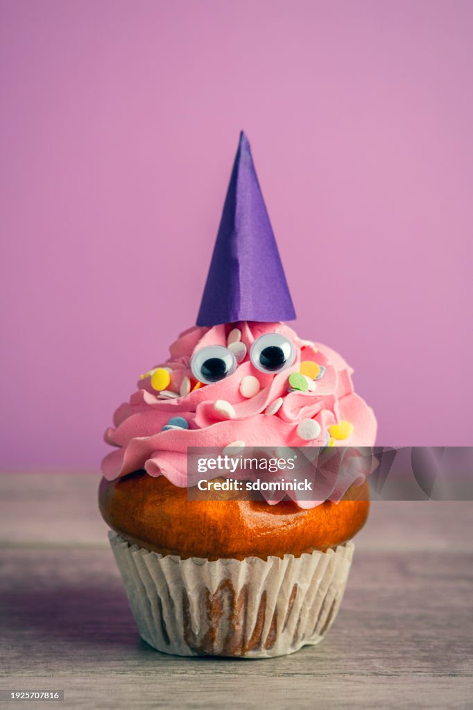 Cupcake With Eyes and Party Hat on Purple