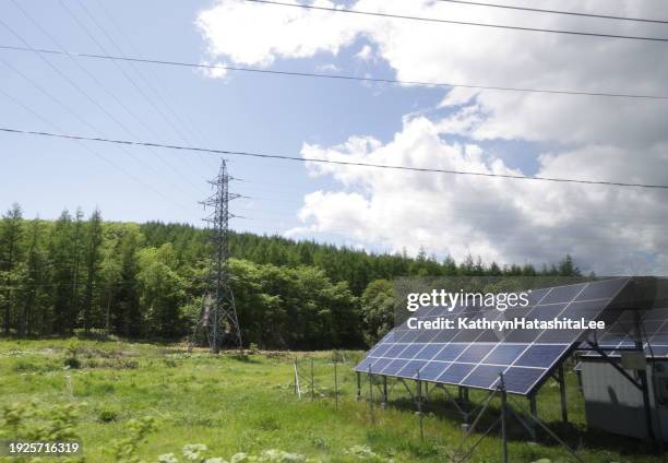 transmissions tower and solar panels in hokkaido, japan - perspective electricity pylon stock pictures, royalty-free photos & images